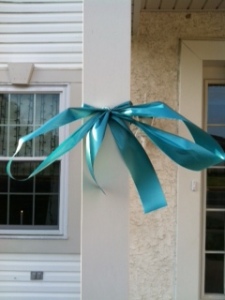 The ribbon to support Ovarian Cancer Awareness on my front porch